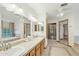 Bright bathroom with double vanity, neutral tile floors, and a separate glass-enclosed shower at 1201 W Dahlia Dr, Phoenix, AZ 85029