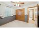 Bedroom with carpet, ceiling fan, window, wood trim, and closet at 1201 W Dahlia Dr, Phoenix, AZ 85029