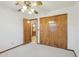 Bedroom featuring neutral carpet, ceiling fan, window, and closet at 1201 W Dahlia Dr, Phoenix, AZ 85029