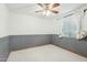 Bedroom with neutral carpet, ceiling fan, window, and decorative chair rail at 1201 W Dahlia Dr, Phoenix, AZ 85029