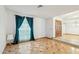 Living room featuring decorative flooring and large window with curtains, providing lots of light at 1201 W Dahlia Dr, Phoenix, AZ 85029