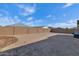 Large backyard features a tall block wall, ready for landscaping and outdoor activities at 12716 W Mclellan Rd, Glendale, AZ 85307