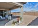 Covered patio with comfortable seating, perfect for enjoying the backyard view at 12716 W Mclellan Rd, Glendale, AZ 85307