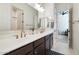 This bathroom features a double sink with a white countertop and dark brown cabinets at 12716 W Mclellan Rd, Glendale, AZ 85307