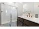 Bathroom showcasing a sleek walk-in shower, vanity with modern sink, and a framed mirror at 12716 W Mclellan Rd, Glendale, AZ 85307