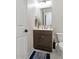 Bathroom with single sink with brown cabinet and white countertop and decorative accessories at 12716 W Mclellan Rd, Glendale, AZ 85307