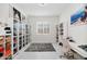 Custom closet with shelving, drawers, and plenty of storage, illuminated by a modern chandelier at 12716 W Mclellan Rd, Glendale, AZ 85307