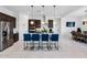 Modern kitchen featuring a large island with seating, stainless steel appliances, and dark wood cabinetry at 12716 W Mclellan Rd, Glendale, AZ 85307