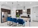 Modern kitchen featuring a large island with seating, stainless steel appliances, and dark wood cabinetry at 12716 W Mclellan Rd, Glendale, AZ 85307