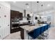 Modern kitchen featuring a large island with seating, stainless steel appliances, and dark wood cabinetry at 12716 W Mclellan Rd, Glendale, AZ 85307