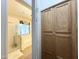 Bright bathroom featuring a glass-enclosed shower, bathtub, and light wood cabinetry for storage at 13594 W Port Royale Ln, Surprise, AZ 85379