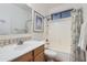 Bright bathroom with a tub and shower combination and a sink with decorative backsplash at 13594 W Port Royale Ln, Surprise, AZ 85379