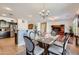 Open concept dining area with a glass table, stylish chairs and a bar top counter at 13594 W Port Royale Ln, Surprise, AZ 85379