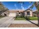 Charming single-story home with a well-maintained lawn and two-car garage in a desirable neighborhood at 13594 W Port Royale Ln, Surprise, AZ 85379