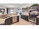 Kitchen area features stainless steel appliances, stone countertops and a breakfast bar at 13594 W Port Royale Ln, Surprise, AZ 85379