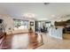 Open living space featuring hardwood flooring, an adjacent dining area, and a modern kitchen at 13594 W Port Royale Ln, Surprise, AZ 85379