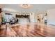 Open-concept living space with hardwood floors, chandelier, and a breakfast bar connecting the kitchen at 13594 W Port Royale Ln, Surprise, AZ 85379