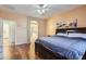 Bedroom with hardwood floors, a ceiling fan and an ensuite bath with a soaking tub at 13594 W Port Royale Ln, Surprise, AZ 85379