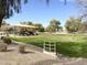 Community playground featuring modern play structures, shade and open green space at 13594 W Port Royale Ln, Surprise, AZ 85379