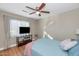 Cozy bedroom featuring a ceiling fan, large window, and light-colored walls, creating a relaxing and comfortable space at 1363 N Mckenna Ln, Gilbert, AZ 85233