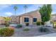 Inviting single-story house with desert landscaping, an arched gate, and excellent curb appeal at 1363 N Mckenna Ln, Gilbert, AZ 85233