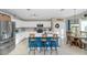 Bright kitchen with white cabinetry, stainless steel appliances, a breakfast bar, and a cozy dining area at 1363 N Mckenna Ln, Gilbert, AZ 85233