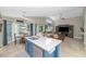 Open concept kitchen featuring a blue island, white countertops, and natural lighting, with a view of the living room at 1363 N Mckenna Ln, Gilbert, AZ 85233