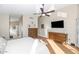 Bedroom with ceiling fan and laminate floors with ensuite bathroom featuring double sinks and separate shower and tub at 1363 N Mckenna Ln, Gilbert, AZ 85233