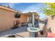 Outdoor patio with fire pit, TV, and comfortable seating under pergola at 1363 N Mckenna Ln, Gilbert, AZ 85233