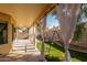 The patio is lined with flowing white curtains looking out at the artificial grass and swing set at 14547 W Evans Dr, Surprise, AZ 85379