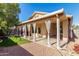 An exterior view of the covered patio that has white flowing curtains overlooking a play area at 14547 W Evans Dr, Surprise, AZ 85379