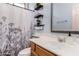 This is a bathroom with updated white counter tops, mirror, and black and white patterned shower curtain at 14547 W Evans Dr, Surprise, AZ 85379