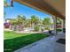 Expansive backyard featuring lush lawn, mature trees, and a fenced pool area for outdoor enjoyment at 14674 W Windsor Ave, Goodyear, AZ 85395