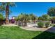 Well-manicured backyard showcasing a sparkling pool area, vibrant greenery, and secure fencing at 14674 W Windsor Ave, Goodyear, AZ 85395