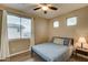 Well-lit bedroom with neutral walls, wood floors, and bright windows at 14674 W Windsor Ave, Goodyear, AZ 85395