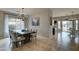 Formal dining room with modern chandelier and views to the backyard at 14674 W Windsor Ave, Goodyear, AZ 85395