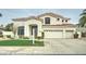 Elegant two-story home featuring a red tile roof, a manicured lawn, and an attached three-car garage at 14674 W Windsor Ave, Goodyear, AZ 85395