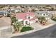 Charming two-story home boasting a red tile roof, lush green lawn, and an attached three-car garage at 14674 W Windsor Ave, Goodyear, AZ 85395