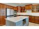 Well-equipped kitchen featuring stainless steel appliances, center island, and wood cabinetry at 14674 W Windsor Ave, Goodyear, AZ 85395