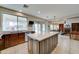 Open concept kitchen with a large island, stainless steel sink and black granite countertops at 14674 W Windsor Ave, Goodyear, AZ 85395