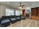 Spacious living room featuring a fireplace, built-in shelves, and hardwood floors at 14674 W Windsor Ave, Goodyear, AZ 85395