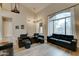 Bright living room with high ceilings, large windows, hardwood floors and modern furniture at 14674 W Windsor Ave, Goodyear, AZ 85395