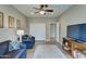 Cozy living room featuring modern gray walls, plush blue couches and a stylish ceiling fan at 14674 W Windsor Ave, Goodyear, AZ 85395