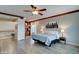 Bright main bedroom boasts wood floors, city skyline art, and a cozy reading nook at 14674 W Windsor Ave, Goodyear, AZ 85395