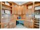 Custom home office featuring lots of wood cabinetry, counter space, and natural light at 14674 W Windsor Ave, Goodyear, AZ 85395