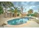 Resort-style pool area with palm trees, rock features and a tropical vibe at 14674 W Windsor Ave, Goodyear, AZ 85395