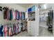 Custom walk-in closet with built-in shelving and ample storage for clothes and accessories at 14674 W Windsor Ave, Goodyear, AZ 85395