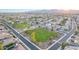 Picturesque aerial view of a neighborhood park with lush green space, walking paths, and nearby residential homes at 15652 N 175Th Ct, Surprise, AZ 85388