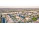 Wide aerial view of a residential neighborhood showcasing homes with pools and solar panels, surrounded by desert landscape at 15652 N 175Th Ct, Surprise, AZ 85388