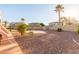 Spacious backyard features desert landscaping and a sun shade on the covered patio at 15652 N 175Th Ct, Surprise, AZ 85388